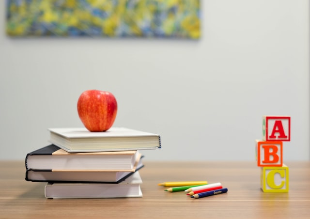 Stack of books with an apple on top