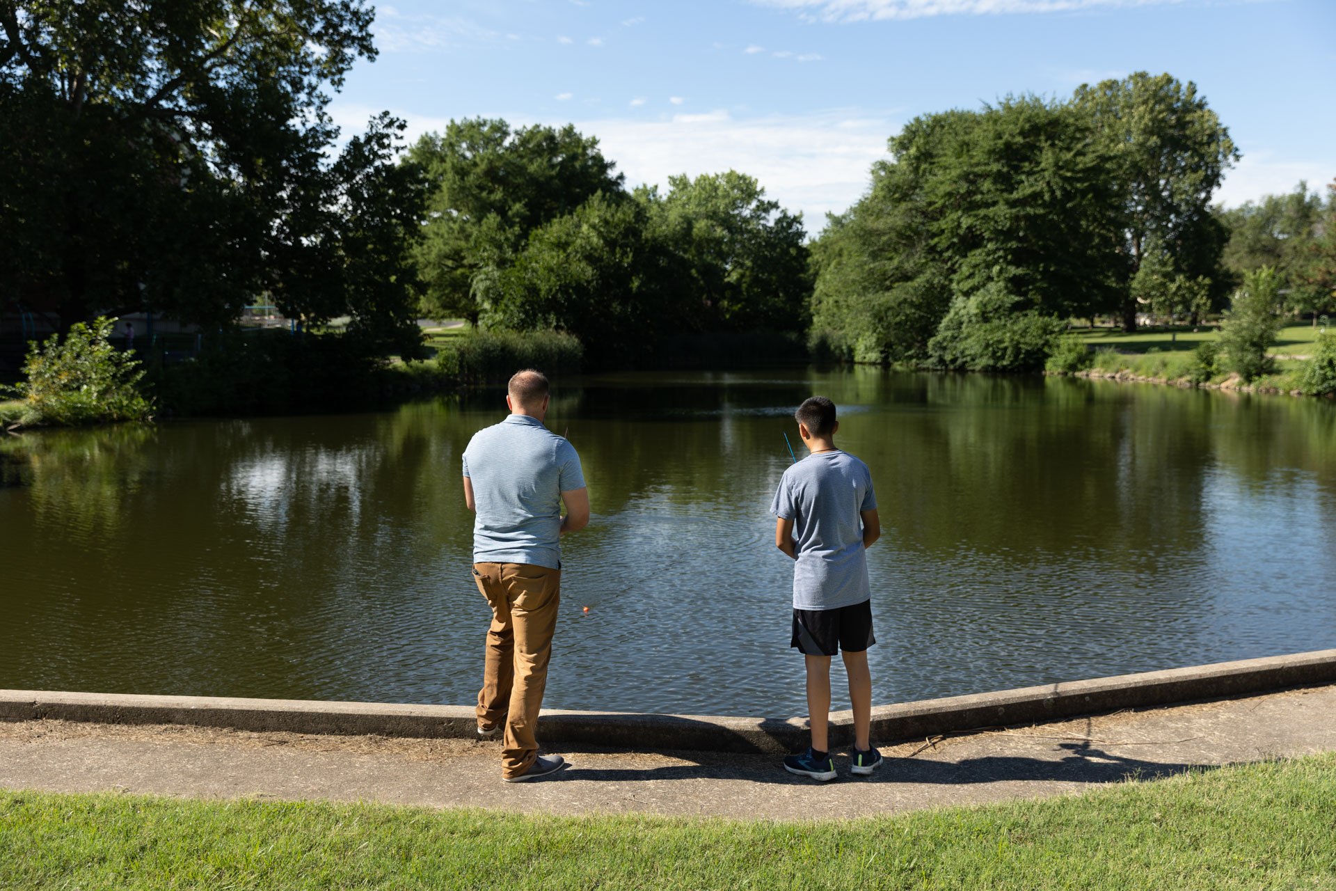 member of staff fishing with child