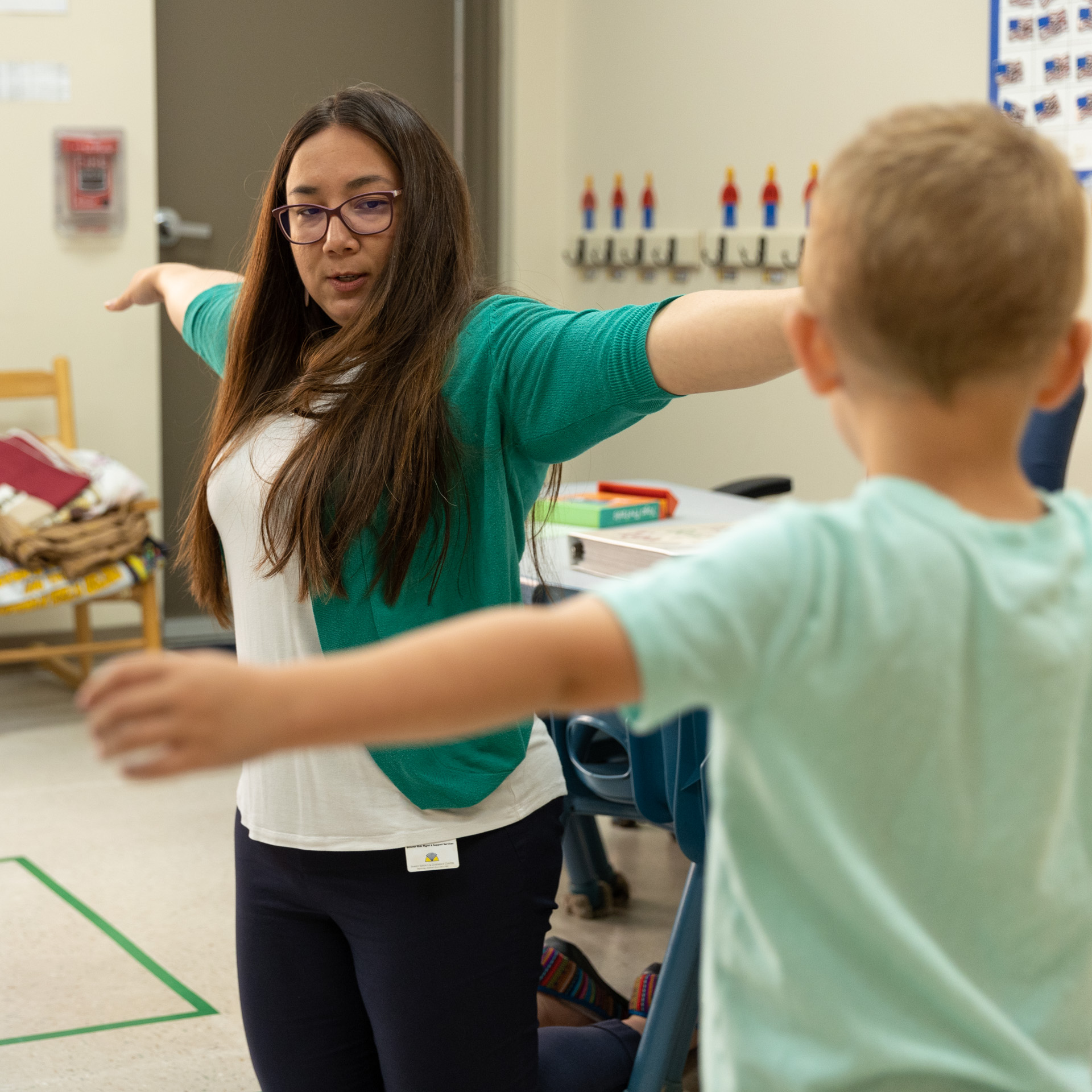 Member of staff teaching kids how to stretch