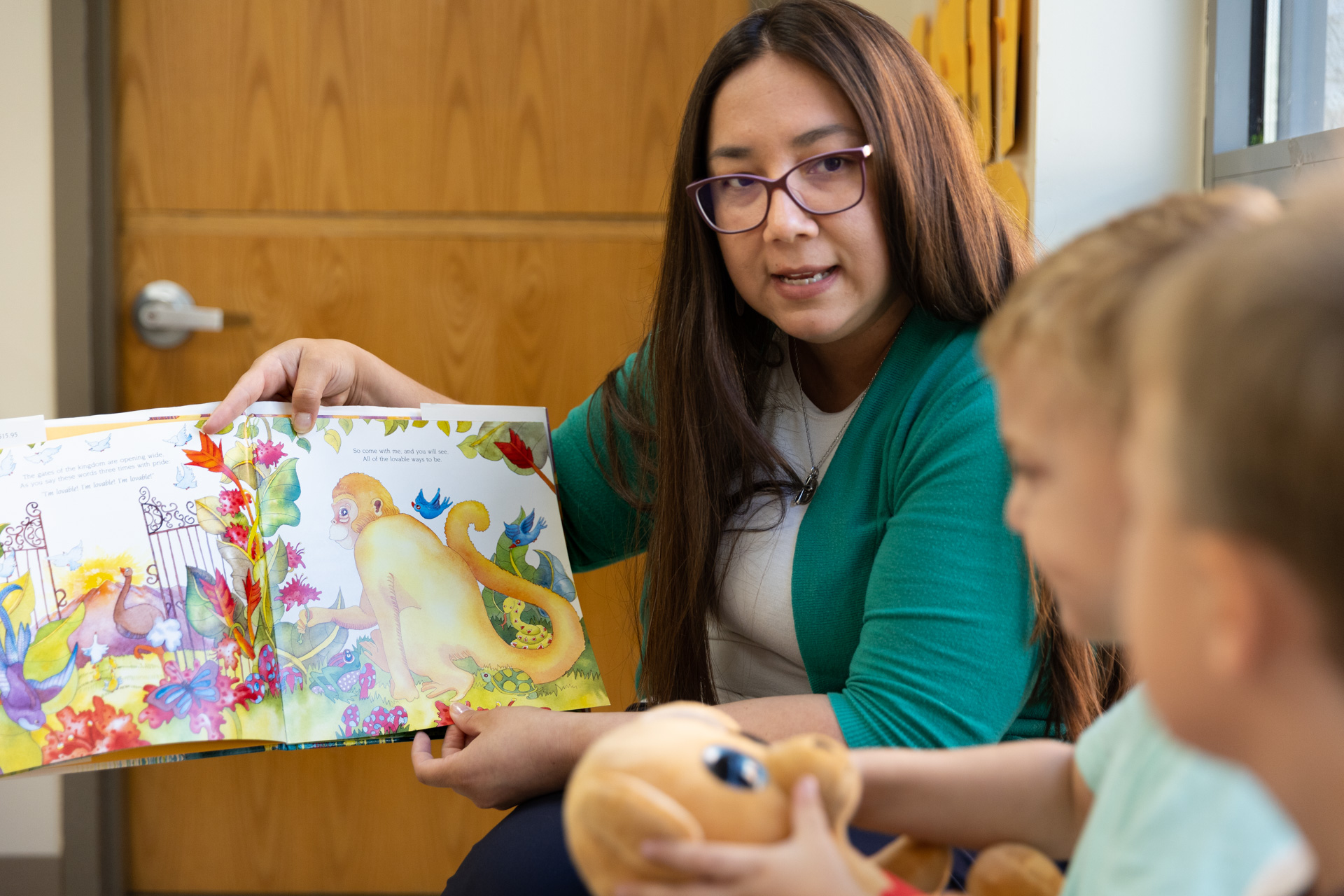 staff reading book to kids