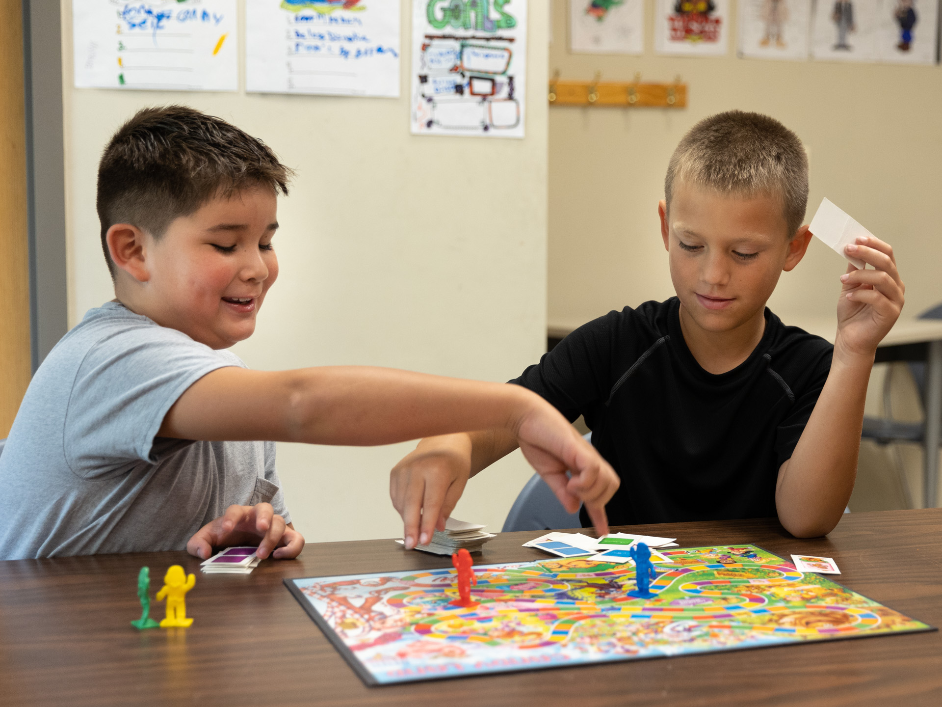 two kids playing Candyland board game